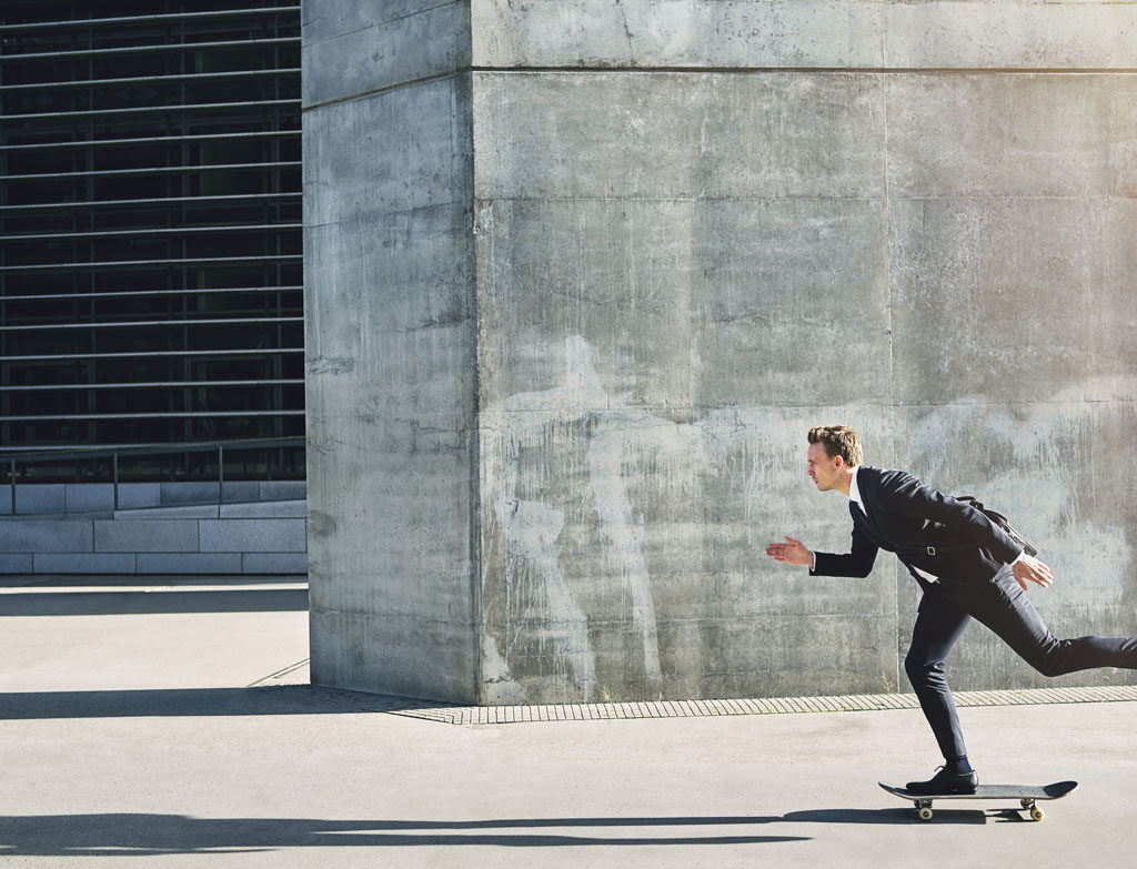 businessman on a skateboard moving forward fast