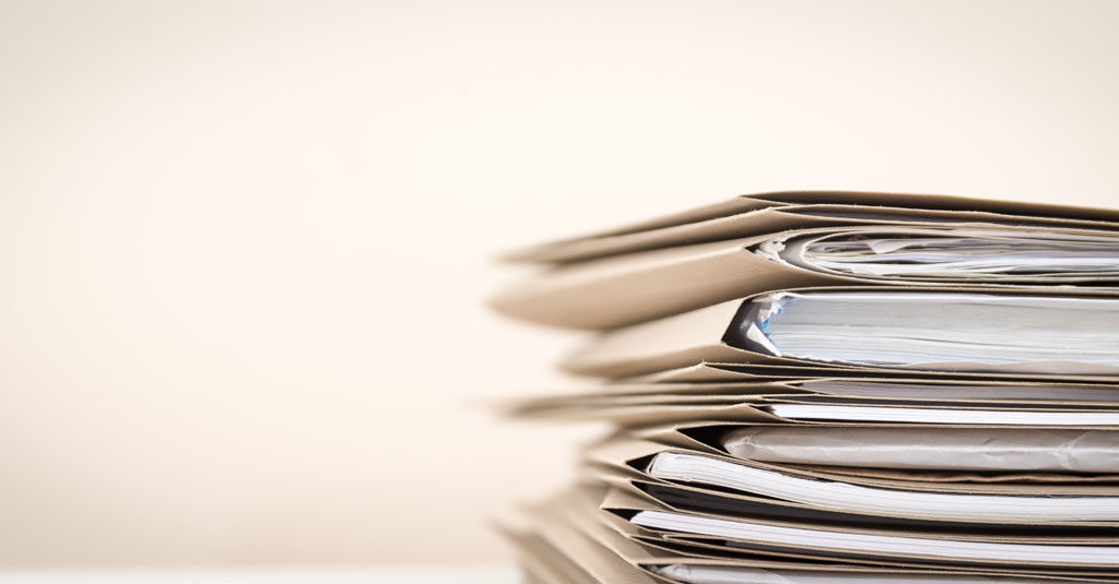 extremely close up stack of documents folders on office desk wai